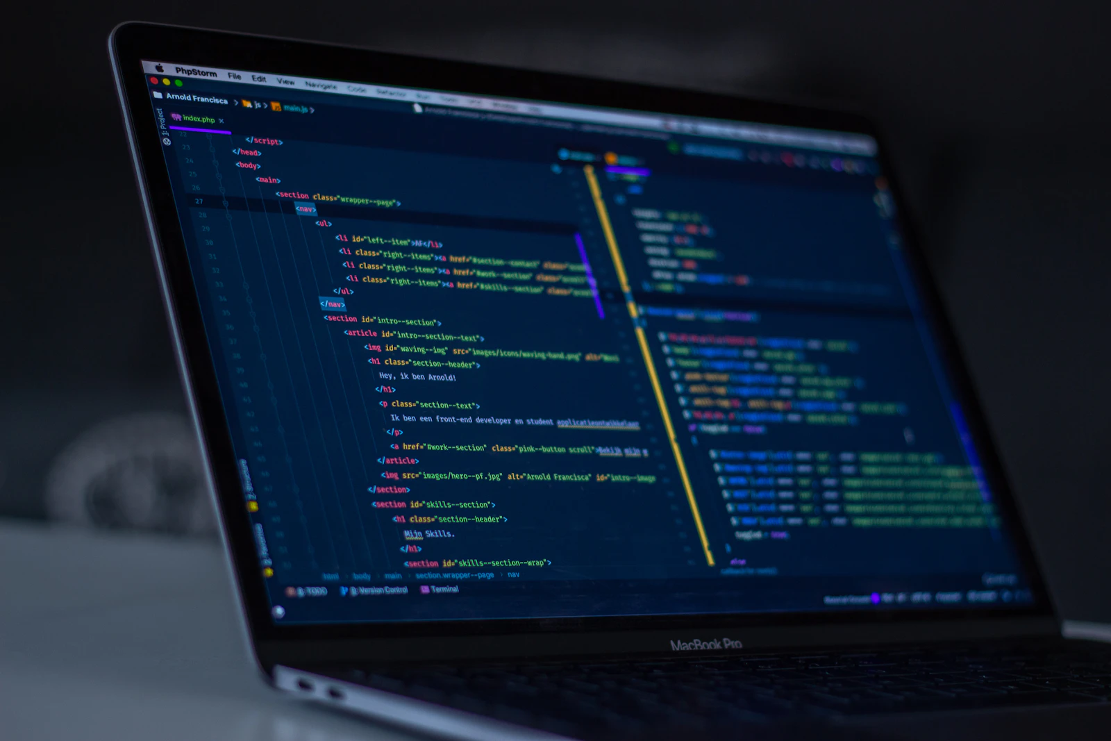 A laptop screen filled with programming code, representing modern custom software development